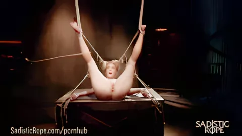 Sadist smacks a whip and a vine tied Mona Vales on the heels and ass