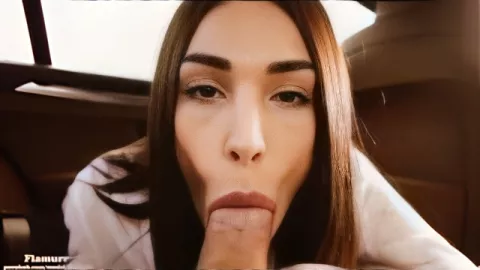A beautiful brunette with plump lips sucks her lover's cock in the car
