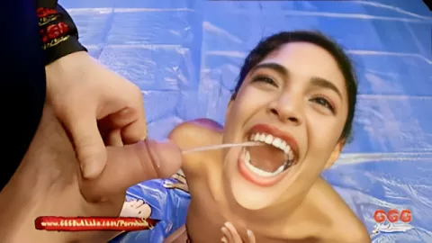 A black woman is fed with cocks and poured with golden rain on blue mats